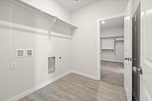 laundry room featuring washer hookup, light hardwood / wood-style floors, and electric dryer hookup