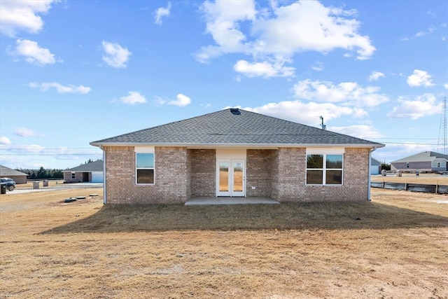 rear view of house with a yard and a patio