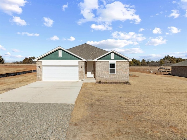 view of front facade featuring a garage and a rural view