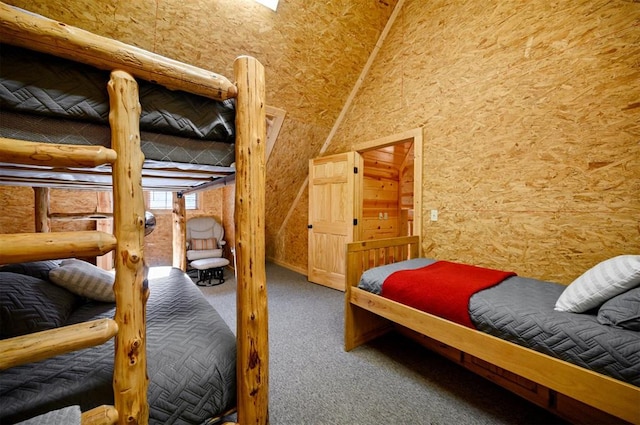 carpeted bedroom with high vaulted ceiling