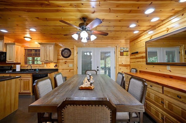 dining area with wood walls, wooden ceiling, french doors, sink, and ceiling fan