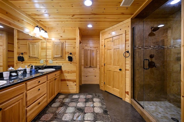 bathroom featuring wood walls, a shower with door, vanity, and wooden ceiling