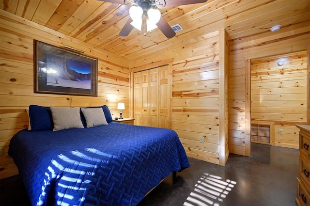 bedroom with ceiling fan, a closet, and wood walls