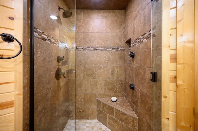 bathroom featuring a shower with shower door