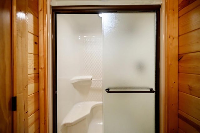 bathroom featuring a shower with door