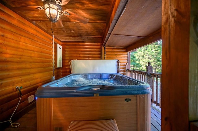 exterior space with ceiling fan and a hot tub