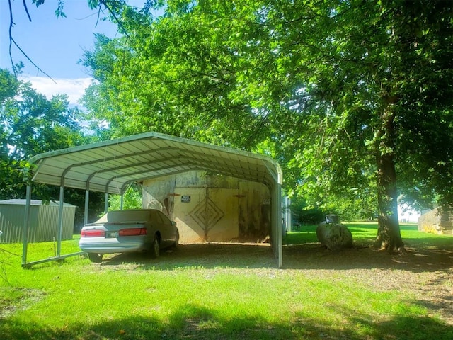 view of parking with a carport and a yard