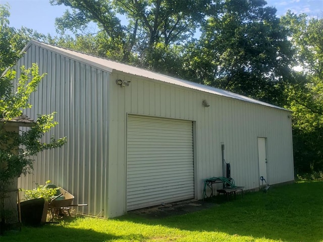 view of outbuilding with a garage and a lawn