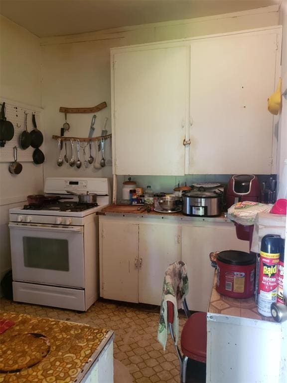 kitchen featuring white cabinetry and gas range gas stove