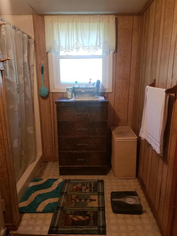 bathroom featuring wood walls