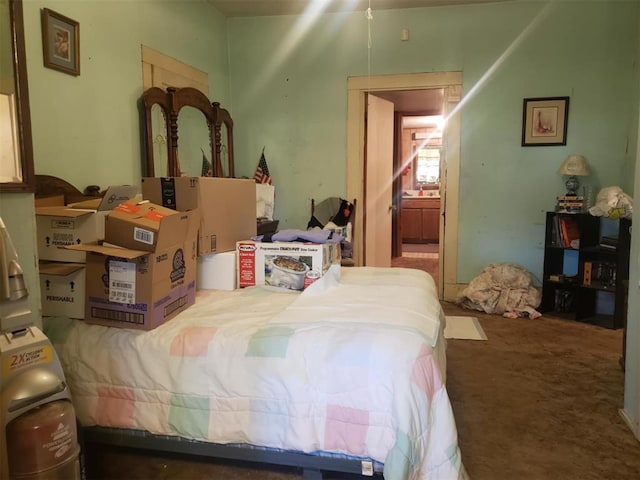 carpeted bedroom featuring connected bathroom