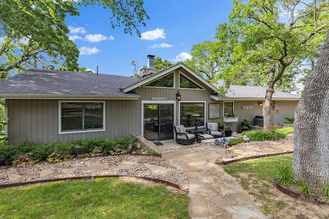 rear view of property featuring outdoor lounge area, a patio area, and central air condition unit