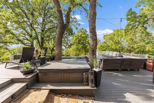 wooden terrace featuring a covered hot tub and an outdoor hangout area