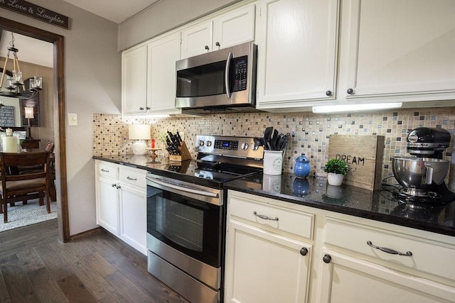 4545 Chickasaw Trl, Sulphur, OK 73086 - kitchen featuring appliances with stainless steel finishes, dark wood-type flooring, dark stone counters, backsplash, and white cabinets