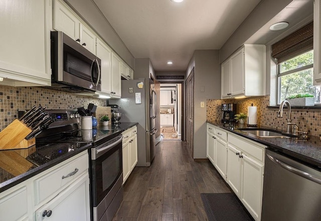 4545 Chickasaw Trl, Sulphur, OK 73086 - kitchen with appliances with stainless steel finishes, a sink, white cabinets, tasteful backsplash, and dark wood-style flooring