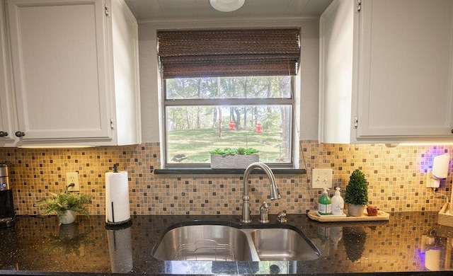 4545 Chickasaw Trl, Sulphur, OK 73086 - kitchen featuring a sink, white cabinetry, dark stone countertops, ornamental molding, and backsplash