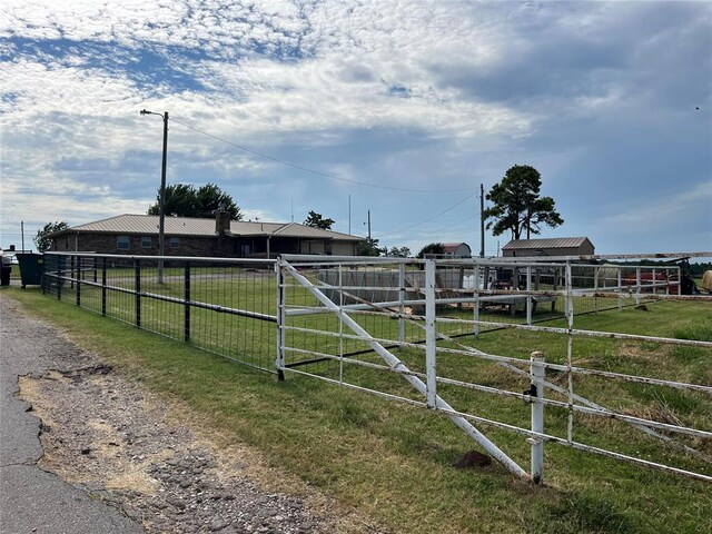 view of yard featuring a rural view and an outbuilding