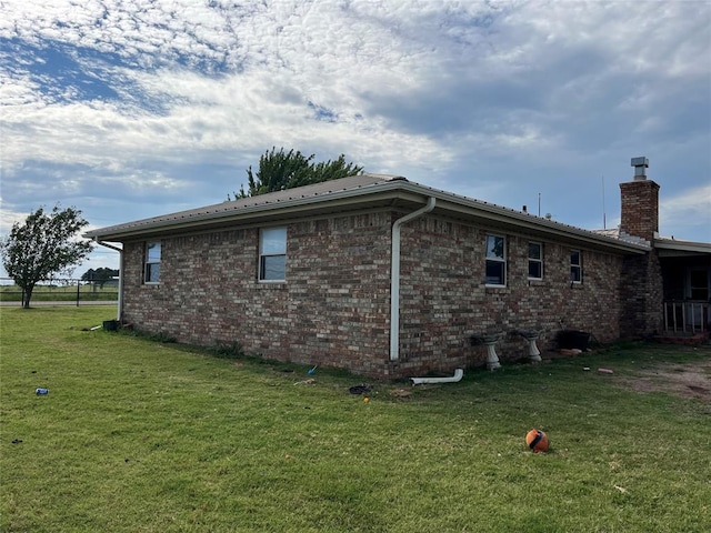 view of side of home featuring a yard