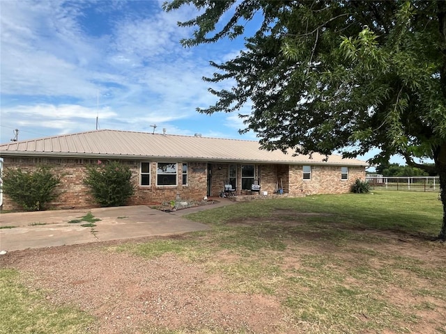 single story home with a patio and a front lawn