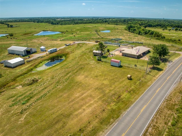 drone / aerial view featuring a rural view and a water view