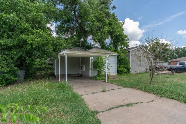 bungalow-style house featuring a carport and a front yard