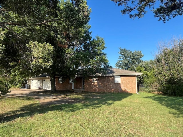 single story home with a garage and a front lawn