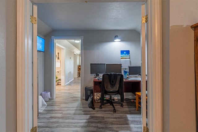 office area featuring hardwood / wood-style floors and vaulted ceiling