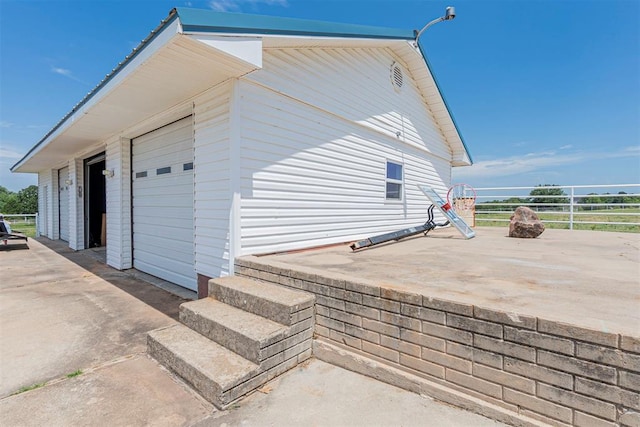 view of side of home featuring an outdoor structure and a garage