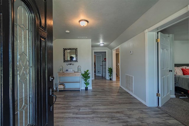 entryway featuring hardwood / wood-style floors and a textured ceiling