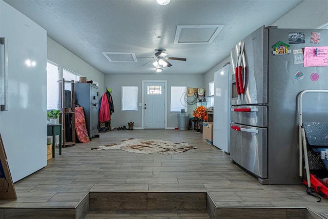 kitchen with stainless steel refrigerator and ceiling fan