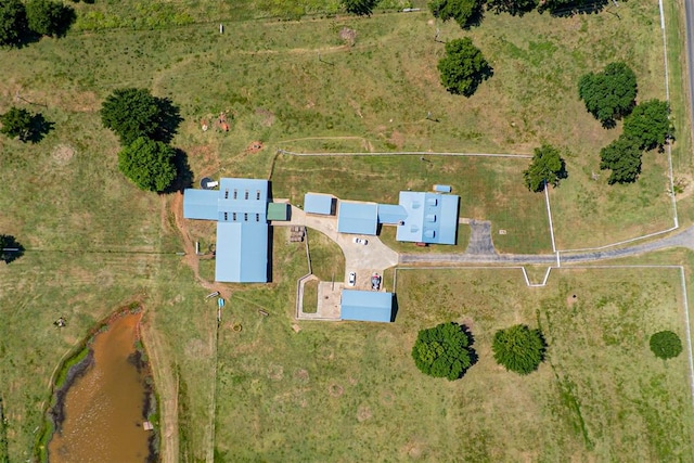 birds eye view of property with a water view and a rural view