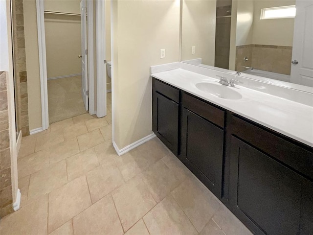 bathroom featuring vanity, toilet, and walk in shower