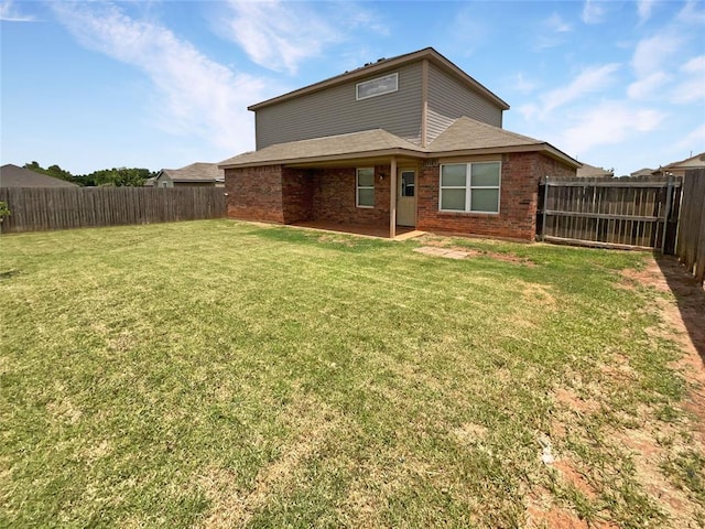 rear view of house with a yard