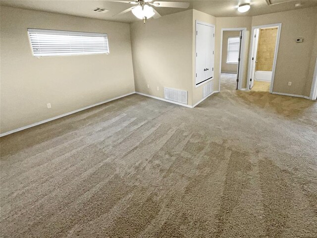 spare room featuring carpet floors and a healthy amount of sunlight