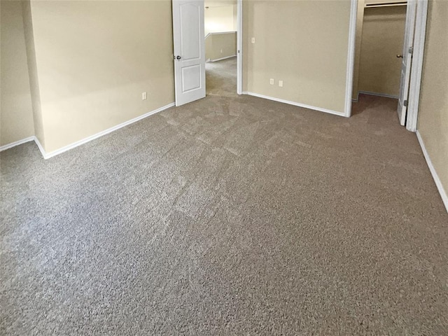 unfurnished bedroom featuring carpet floors and a closet