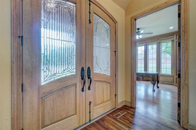 entrance foyer with hardwood / wood-style flooring, ceiling fan, and vaulted ceiling