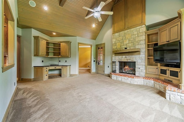 unfurnished living room with ceiling fan, high vaulted ceiling, light carpet, a fireplace, and wood ceiling