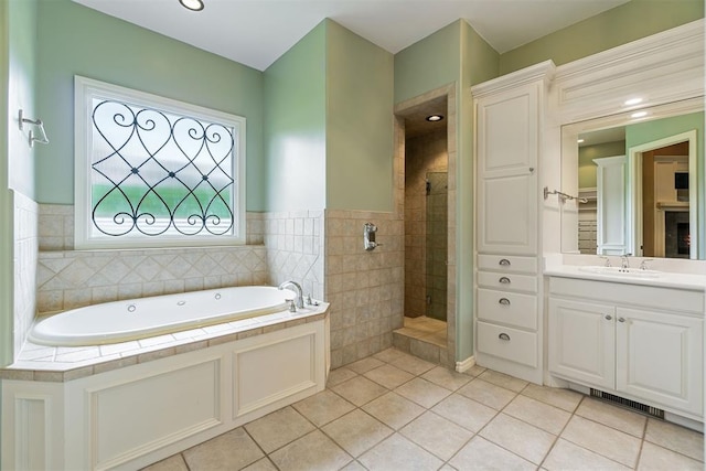 bathroom featuring tile patterned floors, vanity, tile walls, and shower with separate bathtub