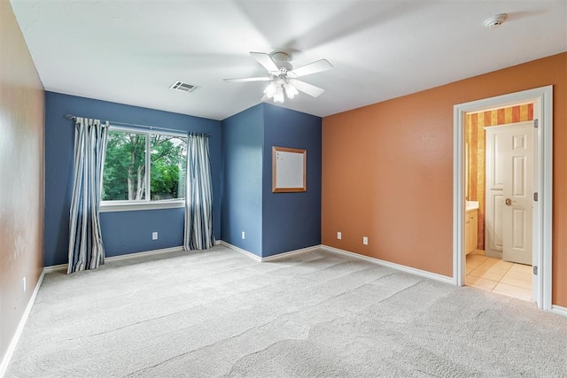 carpeted spare room featuring ceiling fan