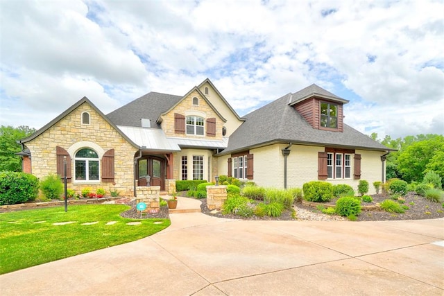 view of front facade featuring a front yard and french doors