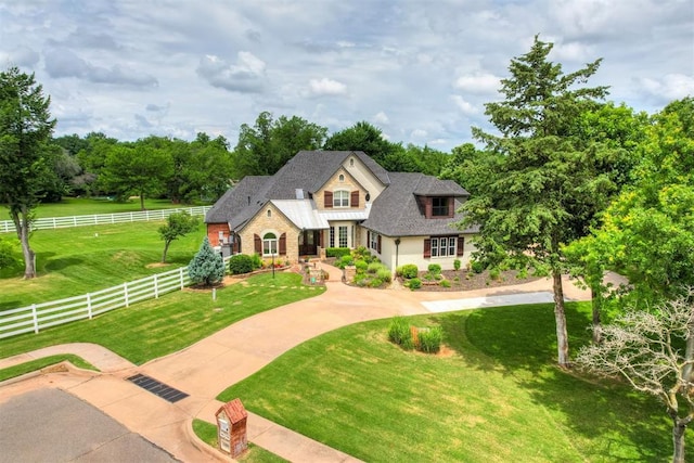 view of front of property with a rural view and a front yard