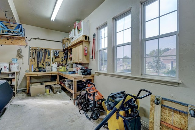 misc room with a workshop area and concrete floors