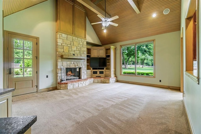 unfurnished living room featuring light colored carpet, high vaulted ceiling, baseboards, wood ceiling, and a ceiling fan