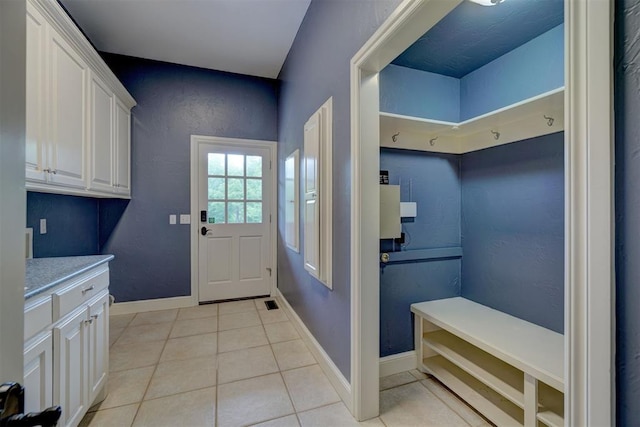 mudroom with light tile patterned floors and baseboards