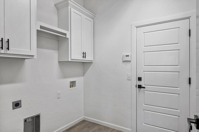 laundry area featuring electric dryer hookup, dark hardwood / wood-style flooring, cabinets, and hookup for a washing machine