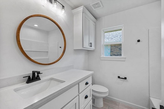 full bathroom featuring washtub / shower combination, vanity, and toilet