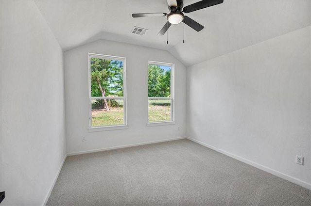 carpeted empty room with ceiling fan and lofted ceiling