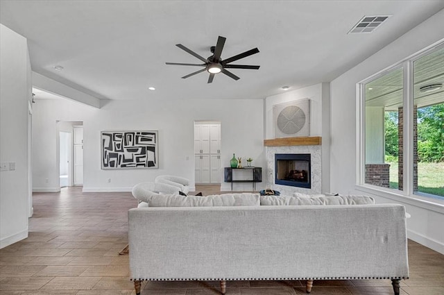 living room featuring ceiling fan and wood-type flooring