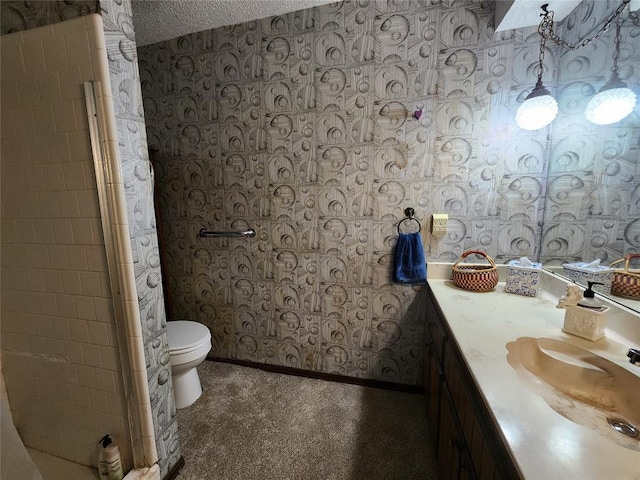 bathroom with vanity, a textured ceiling, and toilet