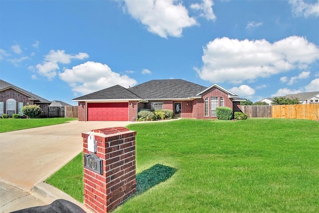 view of front of home featuring a garage and a front yard